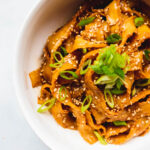 sesame noodles in a bowl.