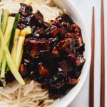Noodles with jajangmyeon sauce and thinly sliced cucumbers on top.