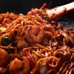 House special lo mein with shrimp and chicken in a wok.