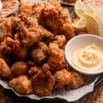 Plate of air fryer karaage on parchment paper with japanese mayo.