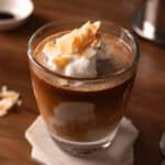 Vietnamese coconut coffee in a glass cup with coconut flakes.