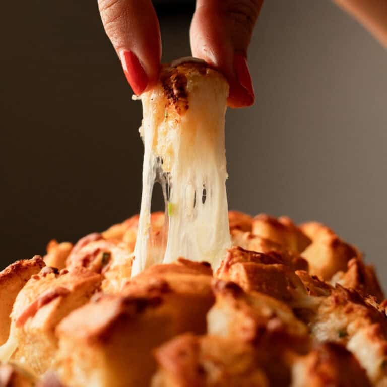 Cheesy garlic pull apart bread with stretchy cheese from bread.