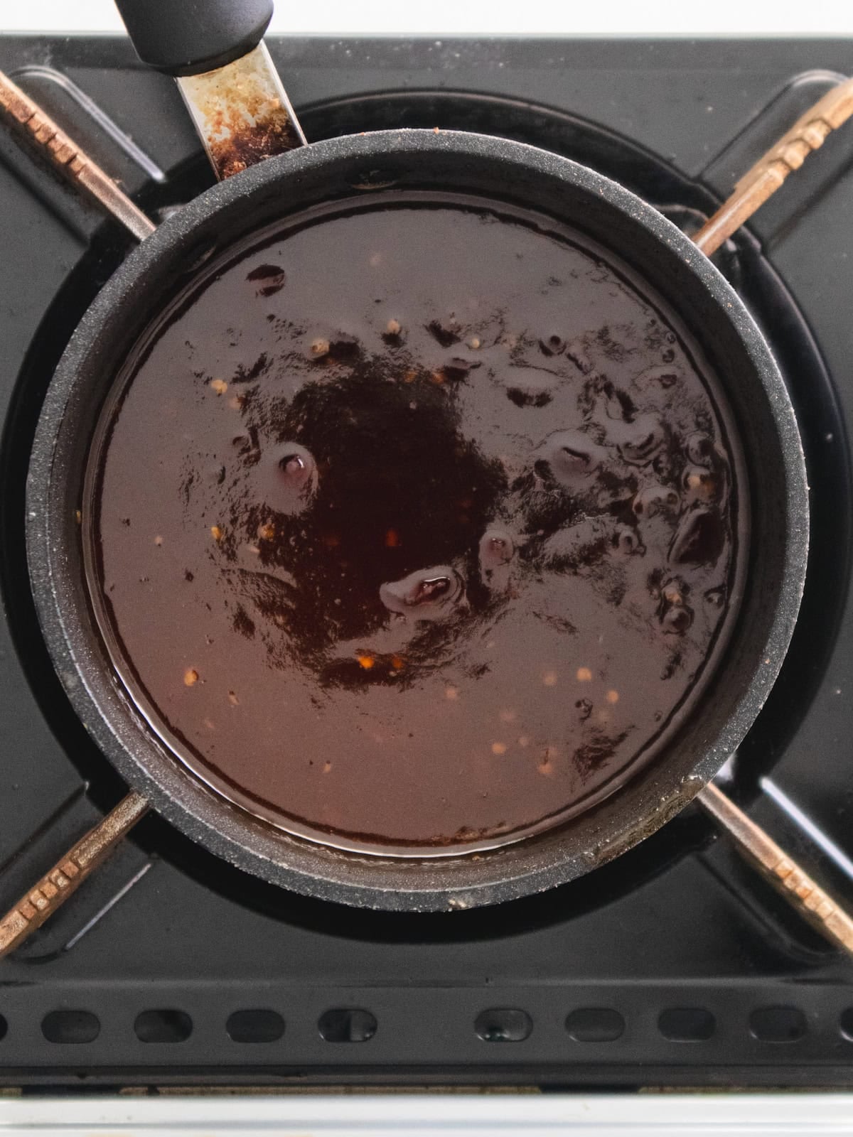 Korean bbq sauce simmering in a saucepot.