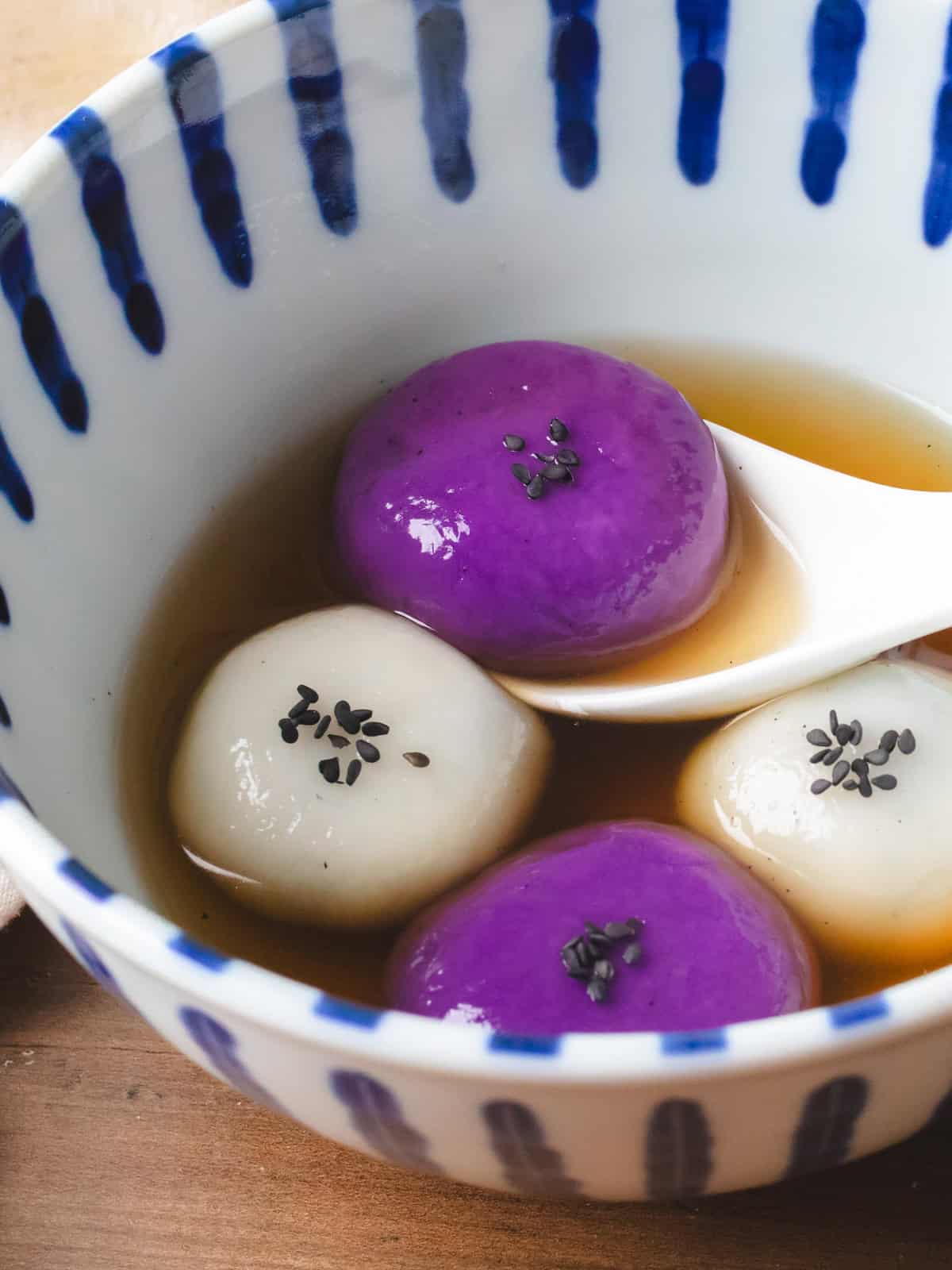 White and blue striped bowl and black sesame tangyuan.