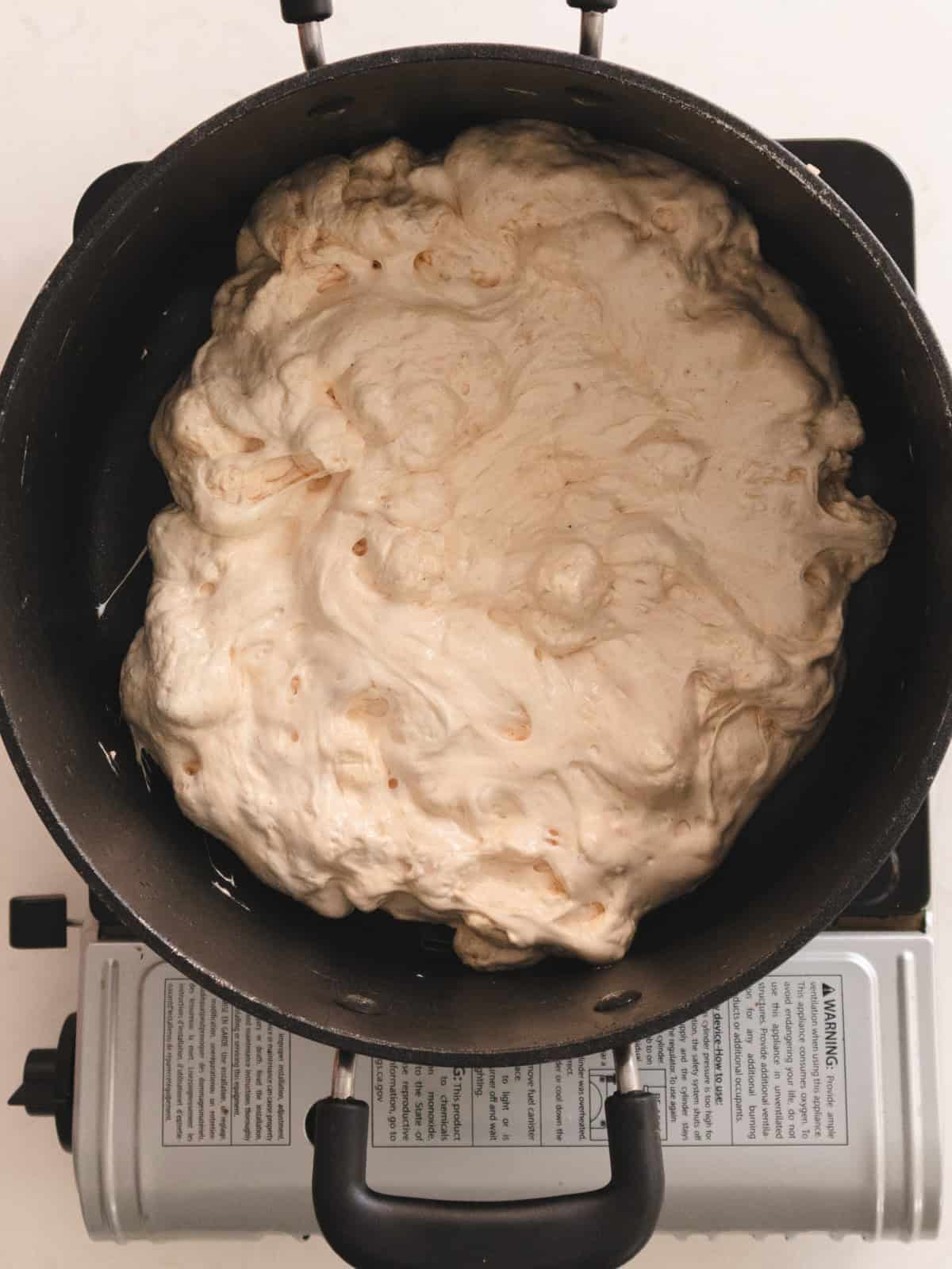 Large black pot of lumpy melted mini marshmellaws.