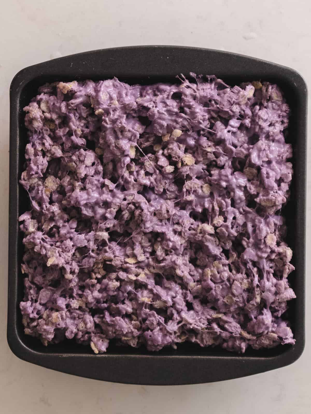 Taro protein rice krispies treats in a baking dish.