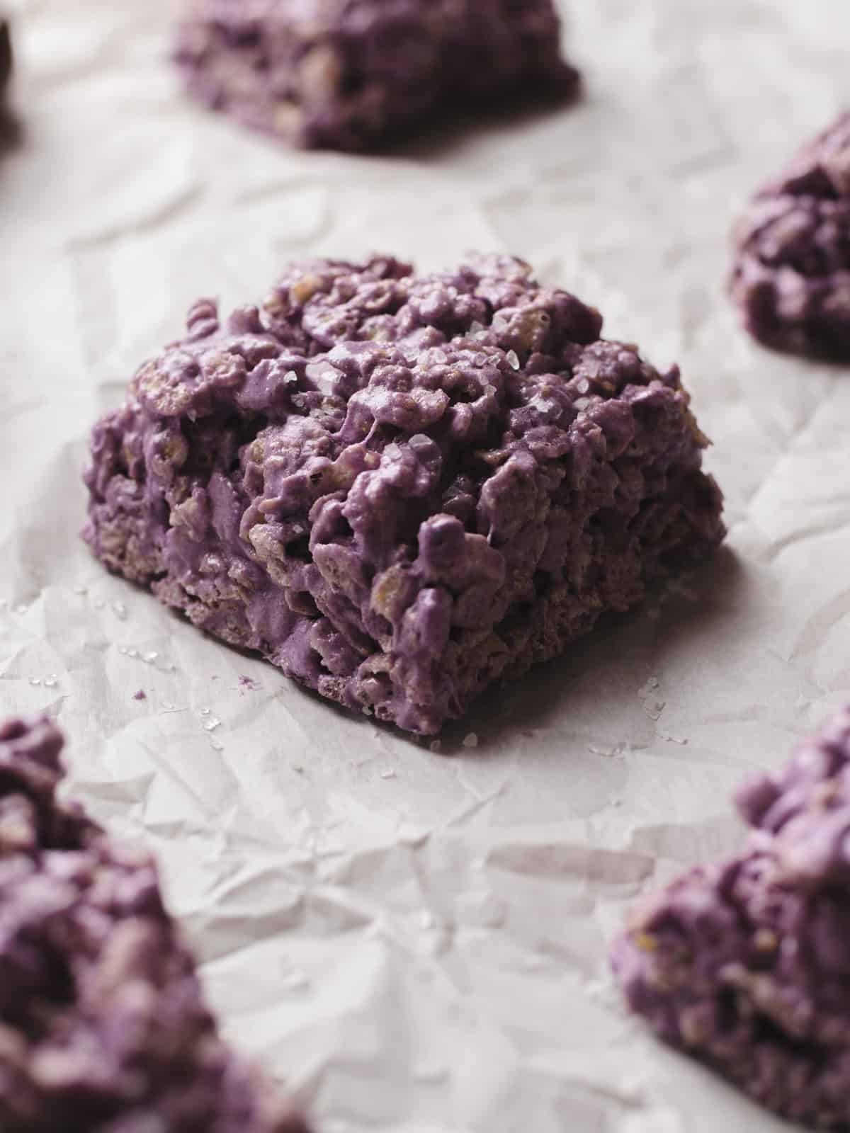Salted taro protein rice krispies treats on parchment-lined baking sheet.
