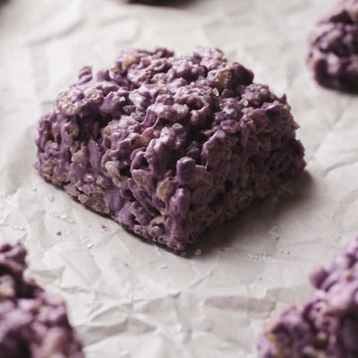 Salted taro protein rice krispies treats on parchment-lined baking sheet.