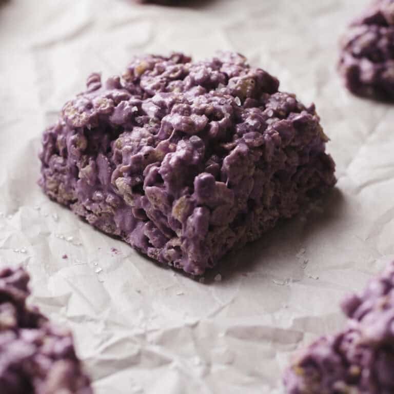 Salted taro protein rice krispies treats on parchment-lined baking sheet.