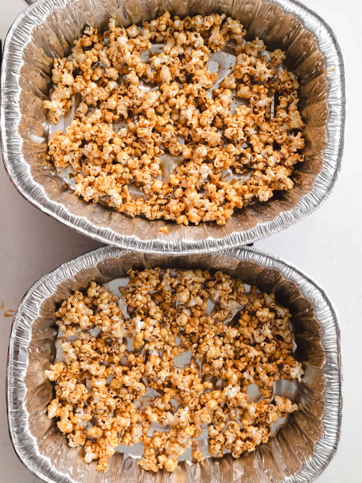 Homemade miso caramel popcorn in two turkey trays.